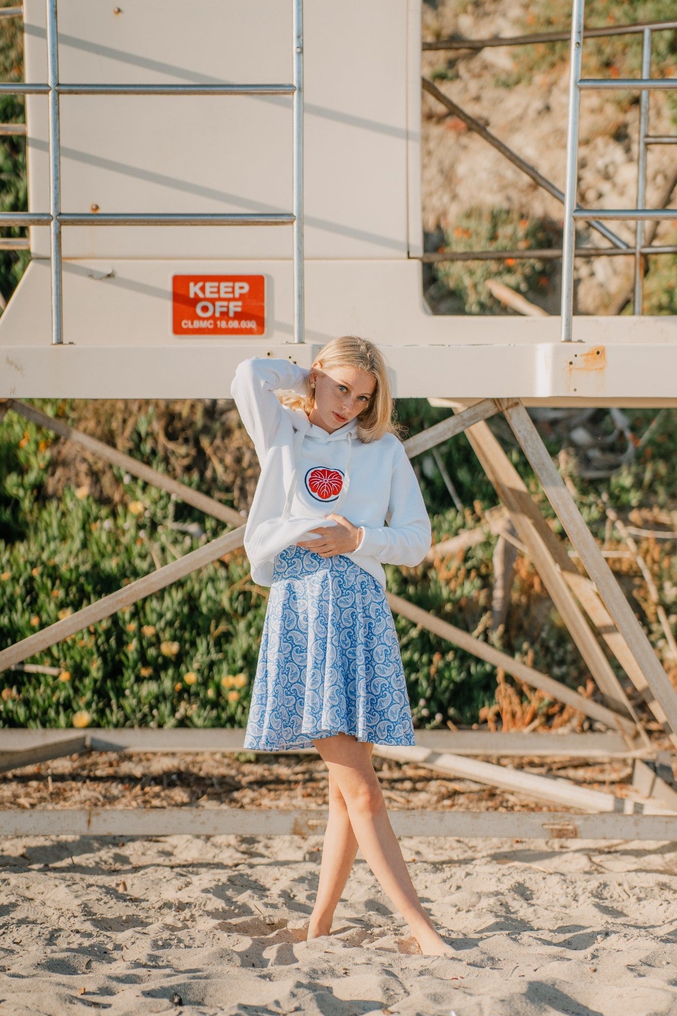Model wearing a dress and a pullover hoodie.