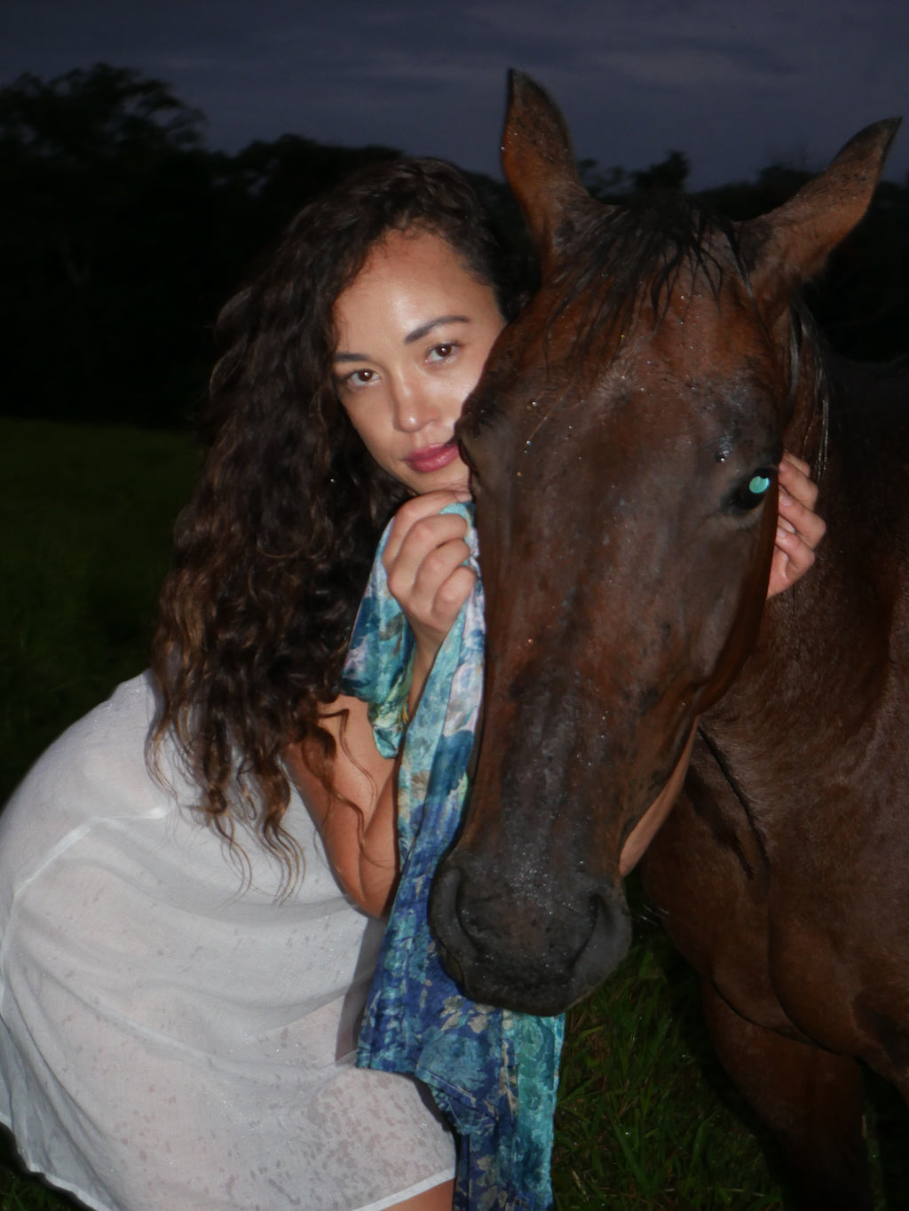 Model in a navy floral silk scarf, photographed at Olson Keolanui Farms in Hilo.