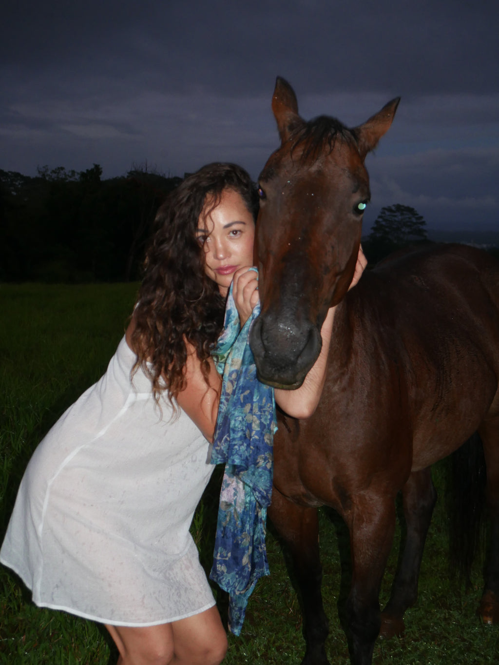 Model in a navy floral silk scarf, photographed at Olson Keolanui Farms in Hilo.